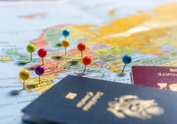 Maps with pins and passports, planning the holidays.